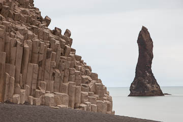 Sea stack and basalt cliffs at Reynisfjara beach, Iceland
