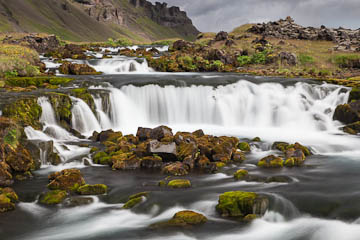 Waterfall along Fossálar River, next to the road, Iceland